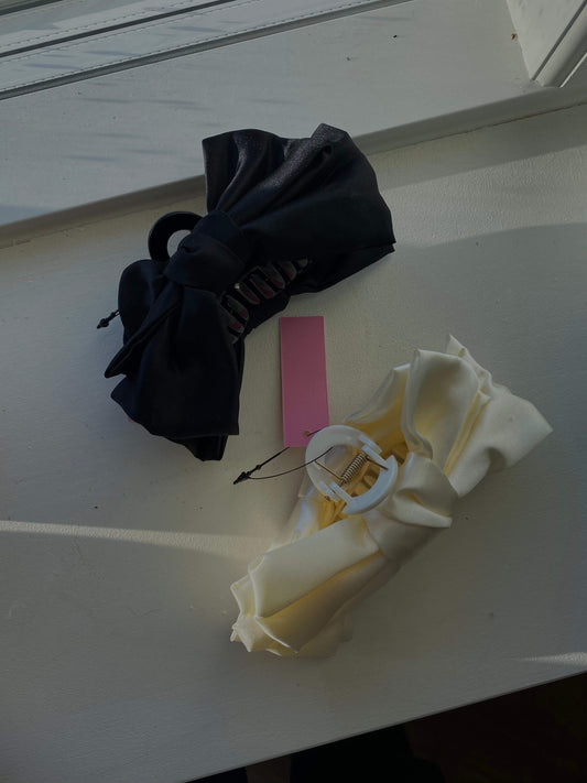Nærbillede af Bow Claw hårklemme i sort og creme, stilfuldt design til håret.